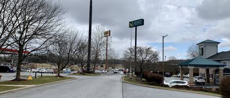 A parking lot with multiple cars, a McDonald's sign, and a Quality Inn & Suites sign.