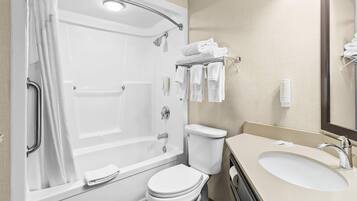 A modern bathroom with a bathtub, toilet, and sink.