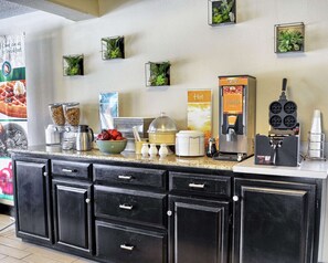 A breakfast bar with a coffee machine, waffle maker, and various food items. - Quality Inn Thornburg (Woodford)