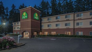 A La Quinta Inn with a central tower, multiple floors, and a parking lot.