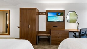 A hotel room with a wooden desk, a television, a mirror, and two beds. - Holiday Inn Express Harlingen by IHG (Harlingen)
