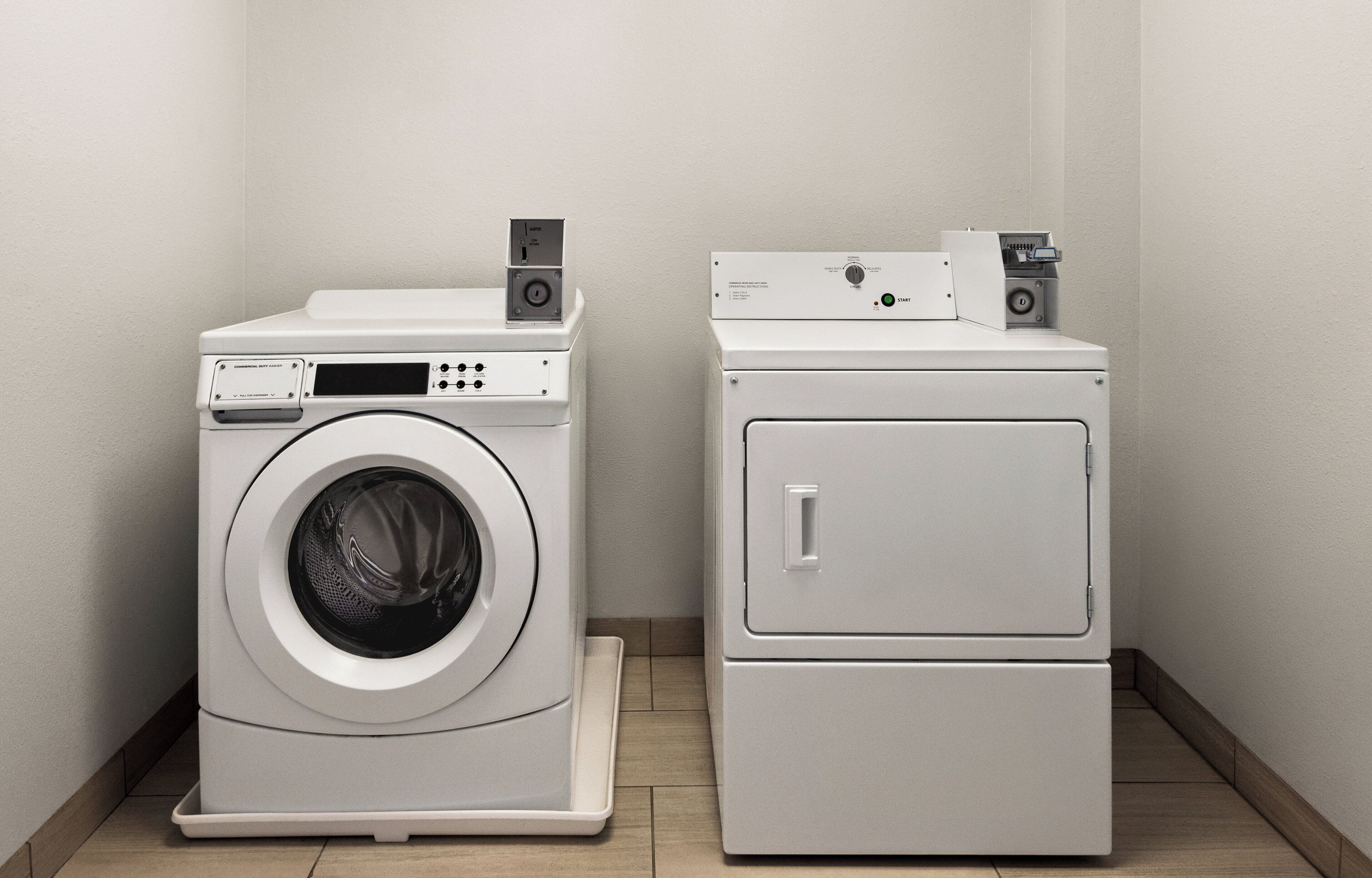 A laundry room with a front-loading washing machine and a stacked dryer.