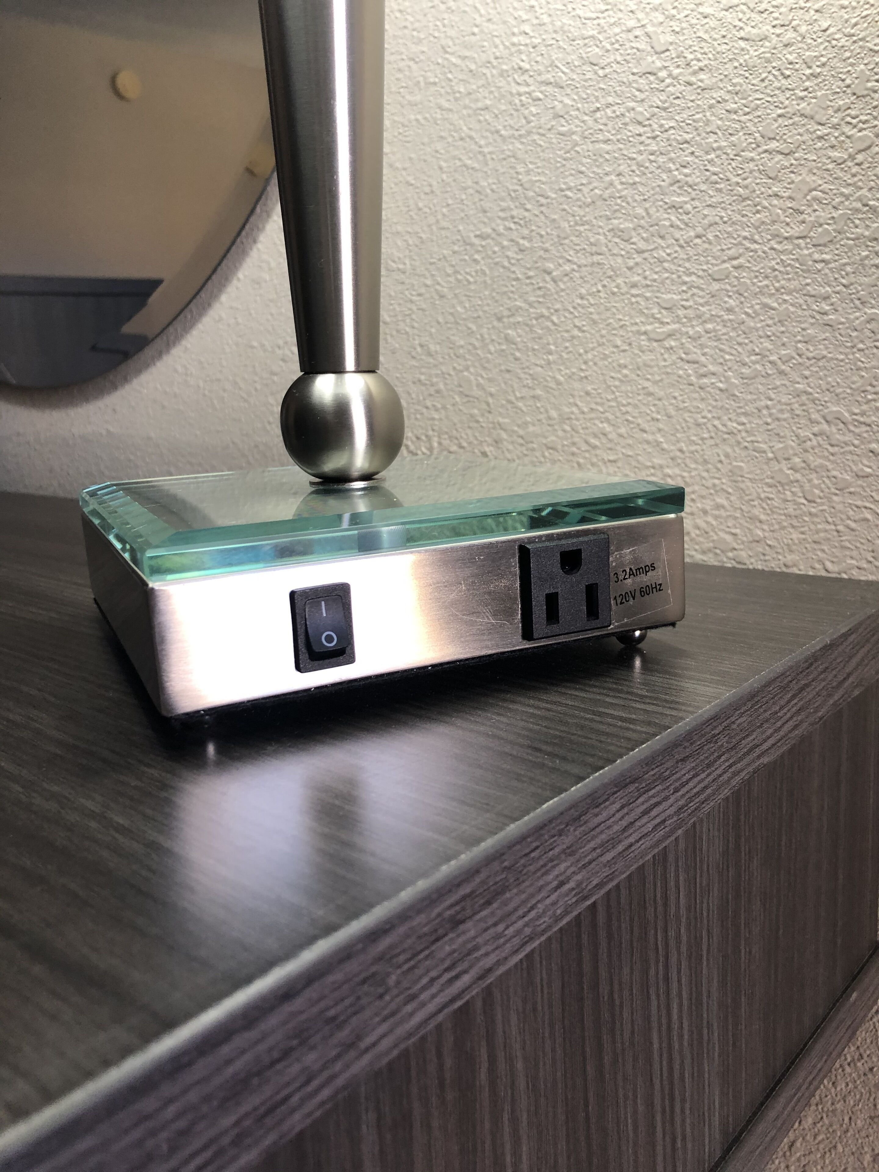 A power strip with a USB port and an electrical outlet on a wooden surface.