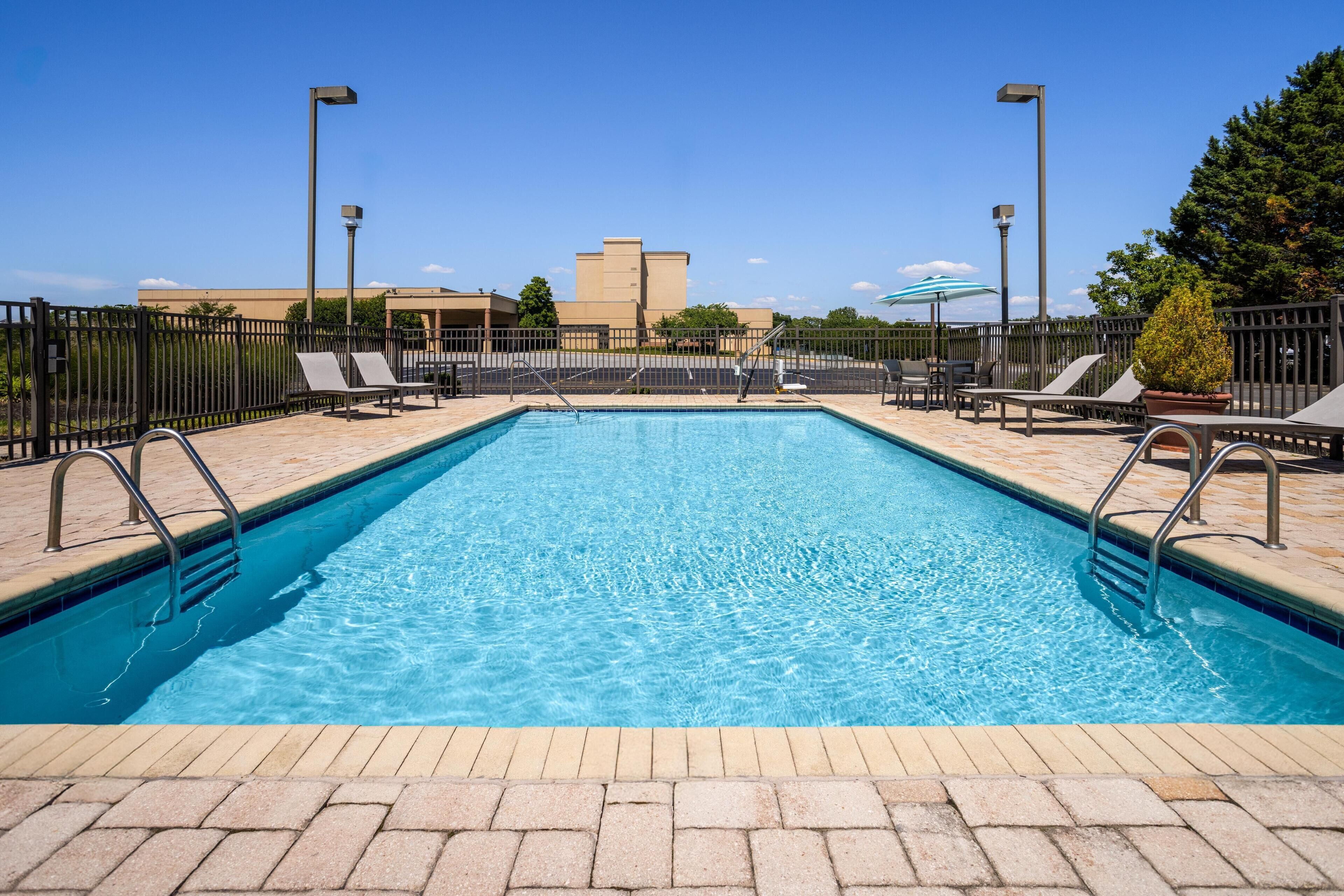 Seasonal outdoor pool, open 10:00 AM to 8 PM, pool umbrellas