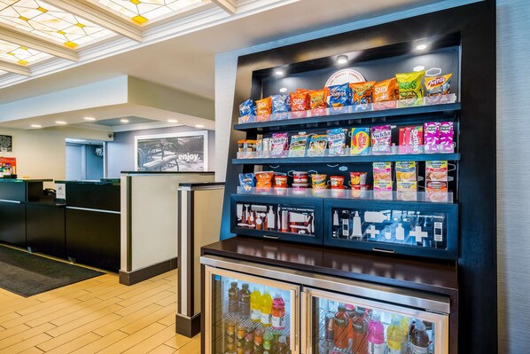 A snack display with various packaged foods and beverages. - Hampton Inn Dover (Dover)