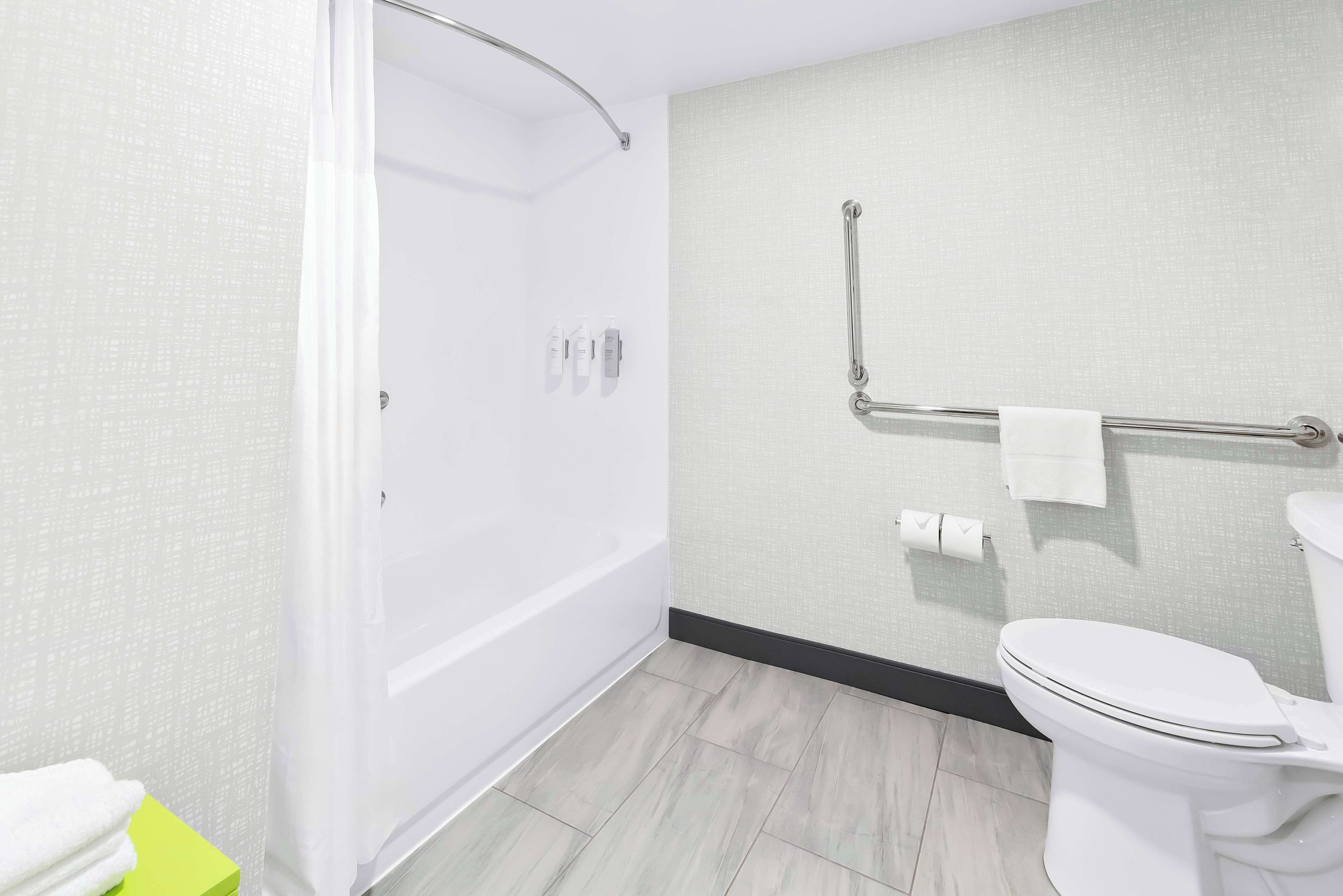 designer toiletries, hair dryer, towels