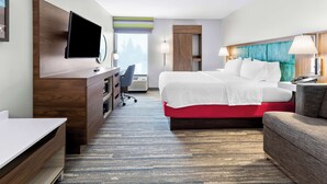 A hotel room with a bed, desk, chair, TV, and a view of the outdoors. - Hampton Inn Washington (Washington)