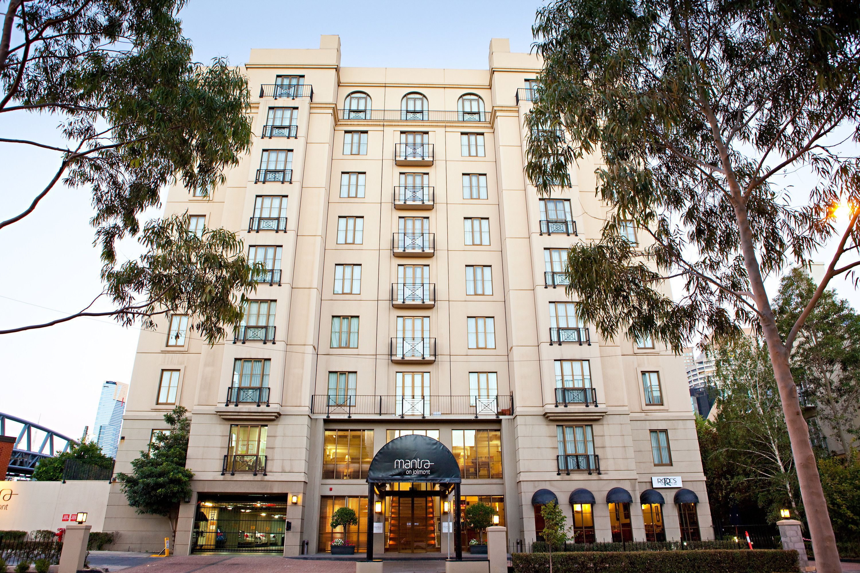A multi-story hotel with a symmetrical facade, large windows, and a central entrance with a canopy. - Mantra on Jolimont Melbourne (East Melbourne)
