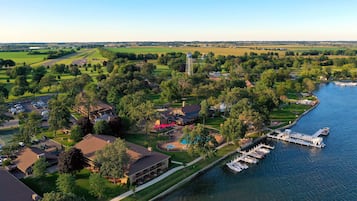 Enjoy a serene riverside setting with a lawn area, swimming pool, and dock, offering opportunities for relaxation and recreation.