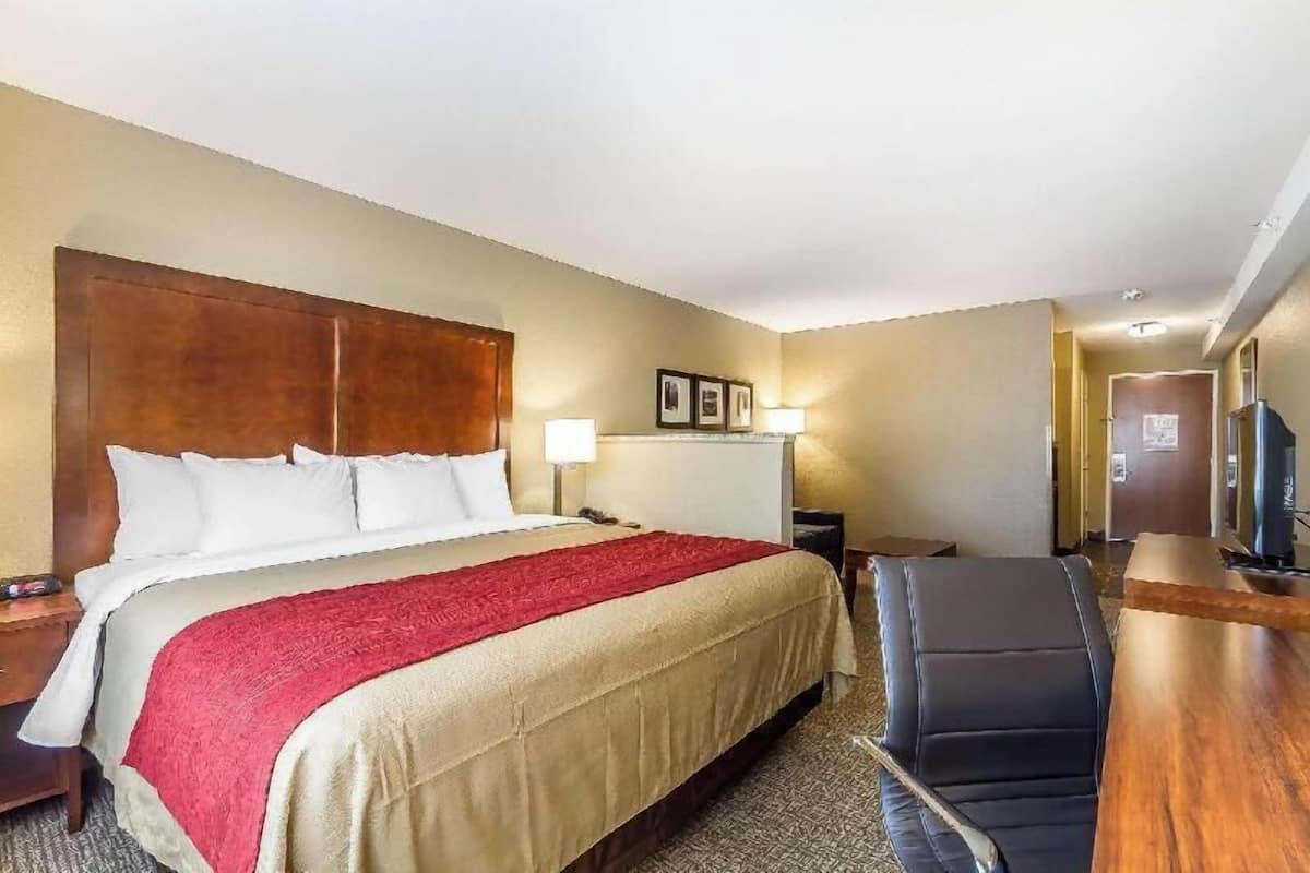 Premium bedding, desk, laptop workspace, blackout drapes