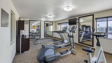 A gym with treadmills, an elliptical, and a stationary bike.
