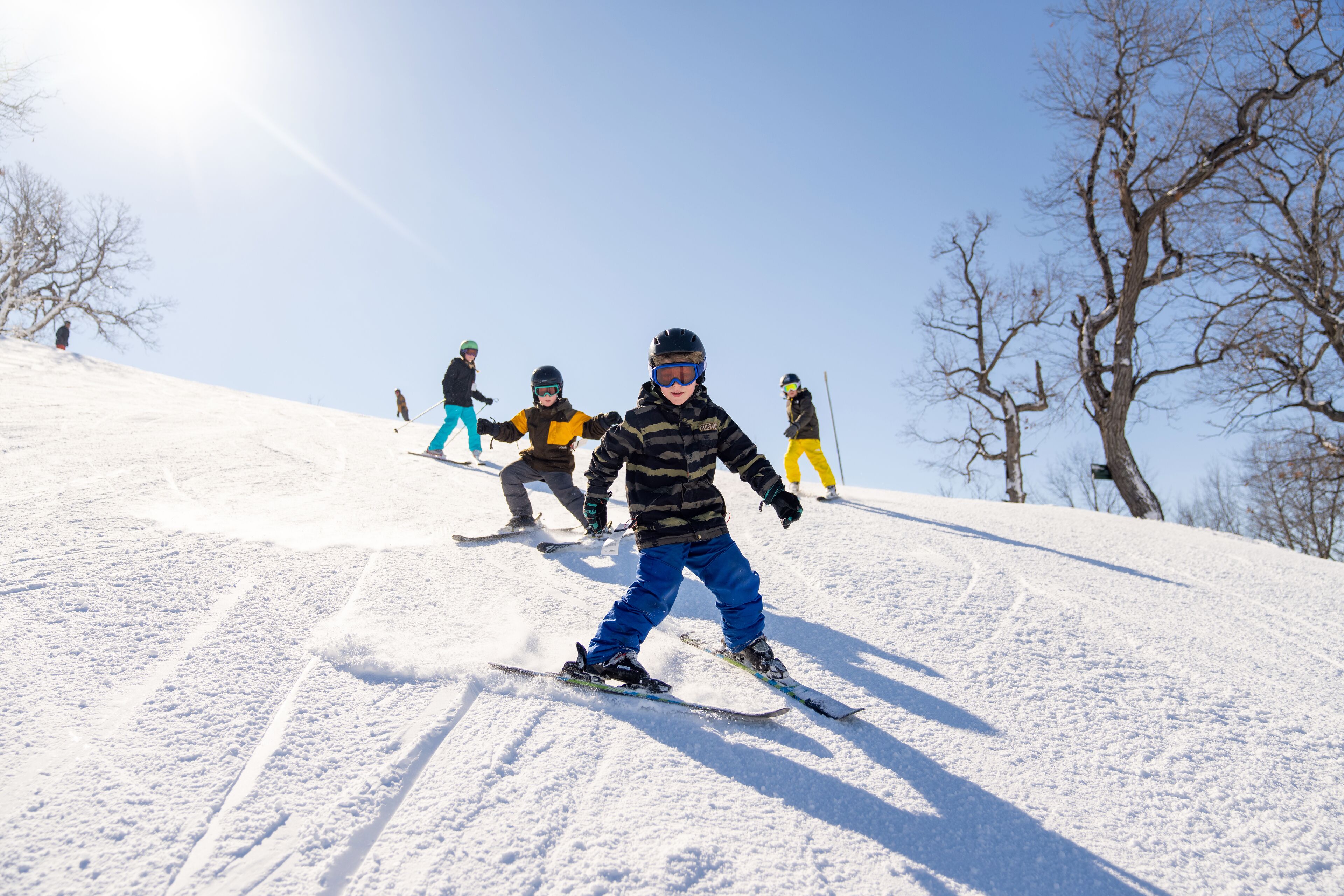 A snowy ski slope with skiers.