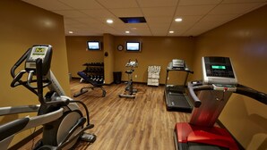 A gym with various exercise equipment including treadmills, elliptical machines, and free weights. - Royal Hotel (Lloydminster)