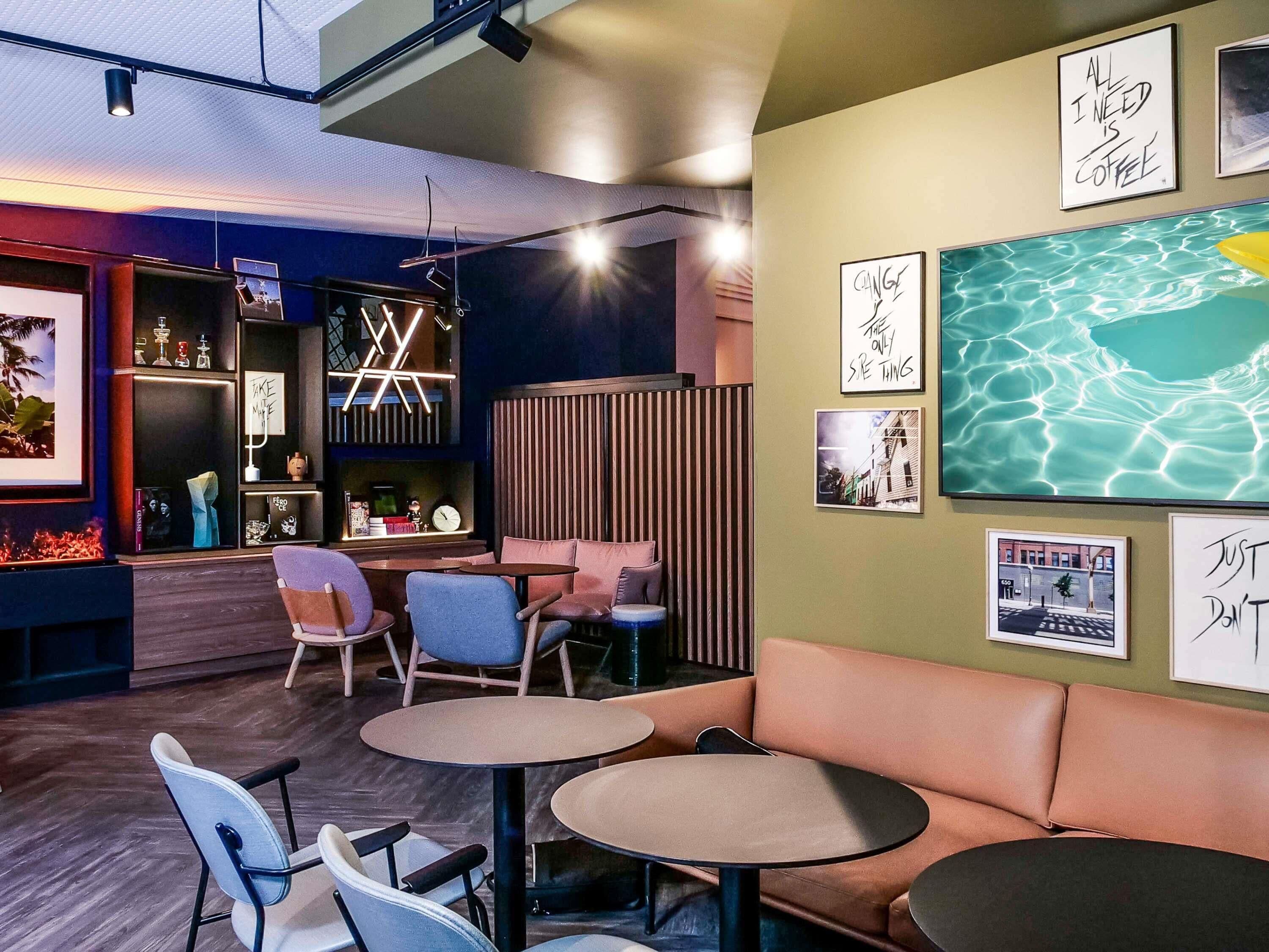 A modern interior with seating, artwork, and a bar area.