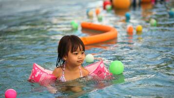 Children can splash and play in the pool surrounded by a variety of fun toys.