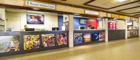 A Pleasant Activities Center with a reception desk, informational posters, and a television screen.