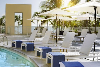 Outdoor pool, sun loungers at The Twin Fin Hotel