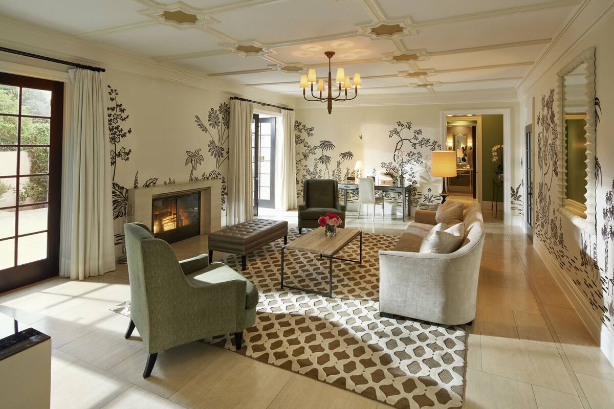 A spacious living room with a fireplace, comfortable seating, and decorative wall art.