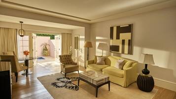 A spacious living room with a sofa, armchair, coffee table, and a rug.