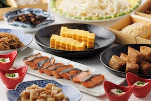 A variety of dishes including salmon, tofu, and noodles.