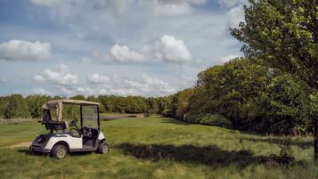 Enjoy a round of golf amidst lush green surroundings and dense tree cover.