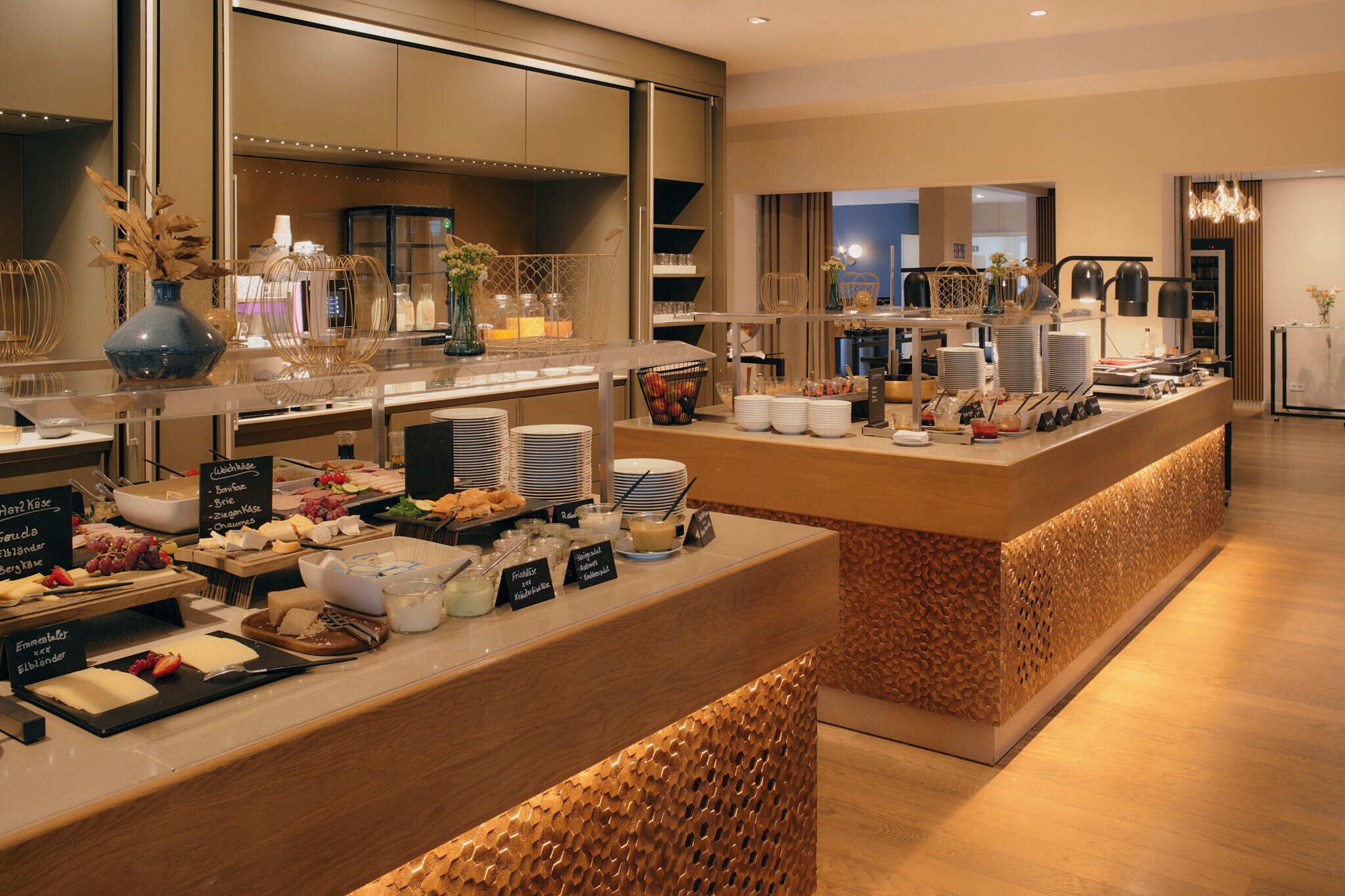 A buffet setup with various food items and serving utensils.