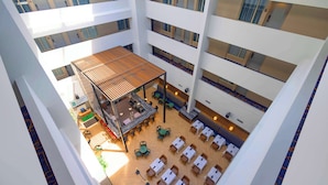 A multi-level hotel atrium with a central open space, multiple floors, and a variety of seating arrangements. - Embassy Suites by Hilton Philadelphia Valley Forge (Wayne)