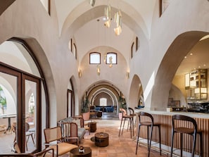 A spacious interior with arched ceilings, a bar area, seating, and a view through large windows. - Mövenpick Resort El Quseir (El Quseir)