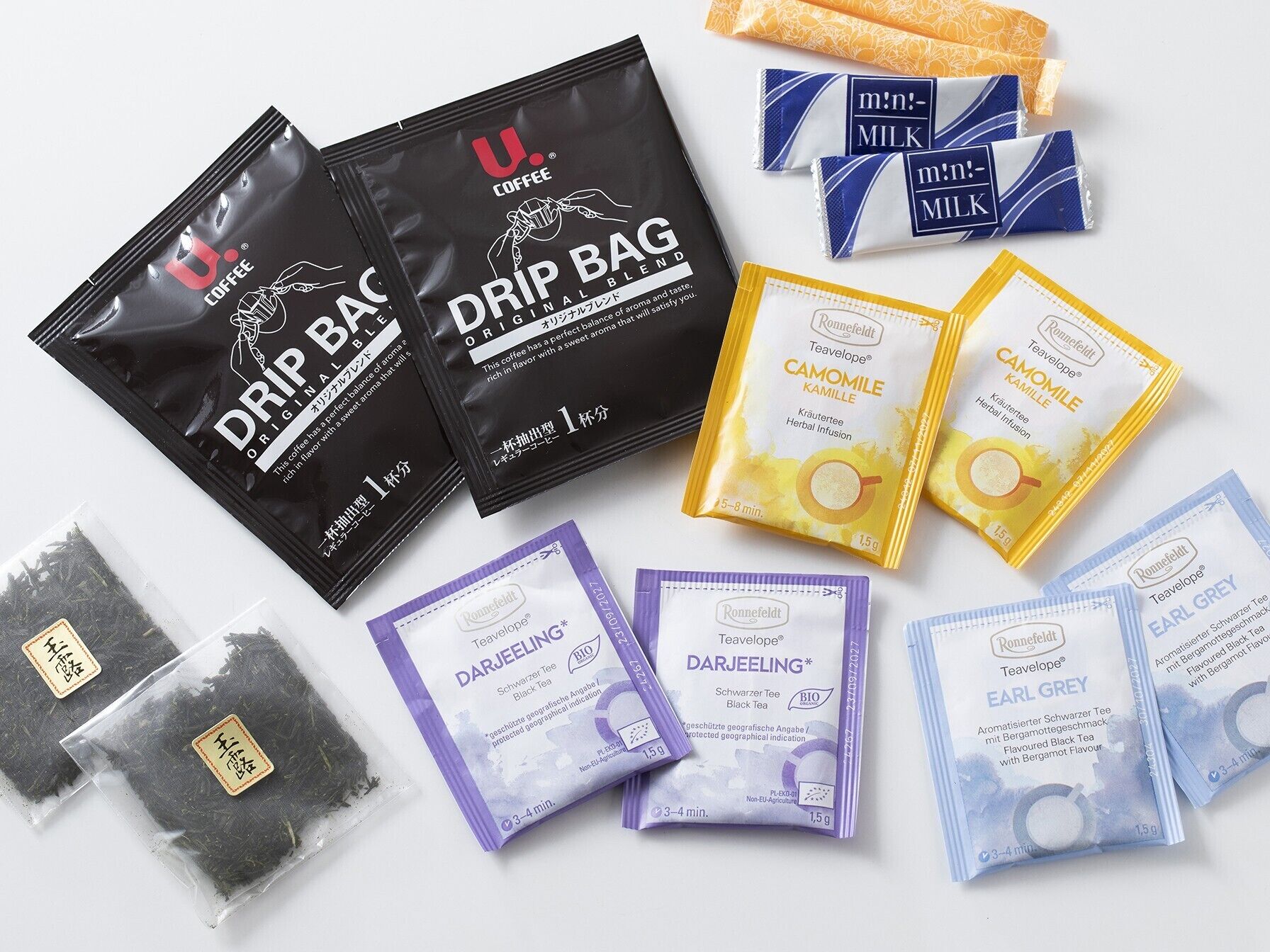 Various tea products including U. Coffee Drip Bag, Camomile Kamille, Darjeeling, Earl Grey, and milk-flavored teas.