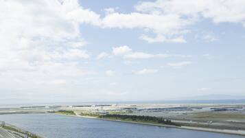 A view of an airport with a river in the foreground and a clear sky.