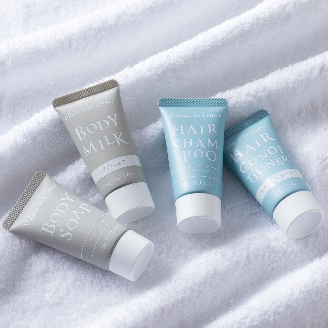 Three toiletry items on a white towel.