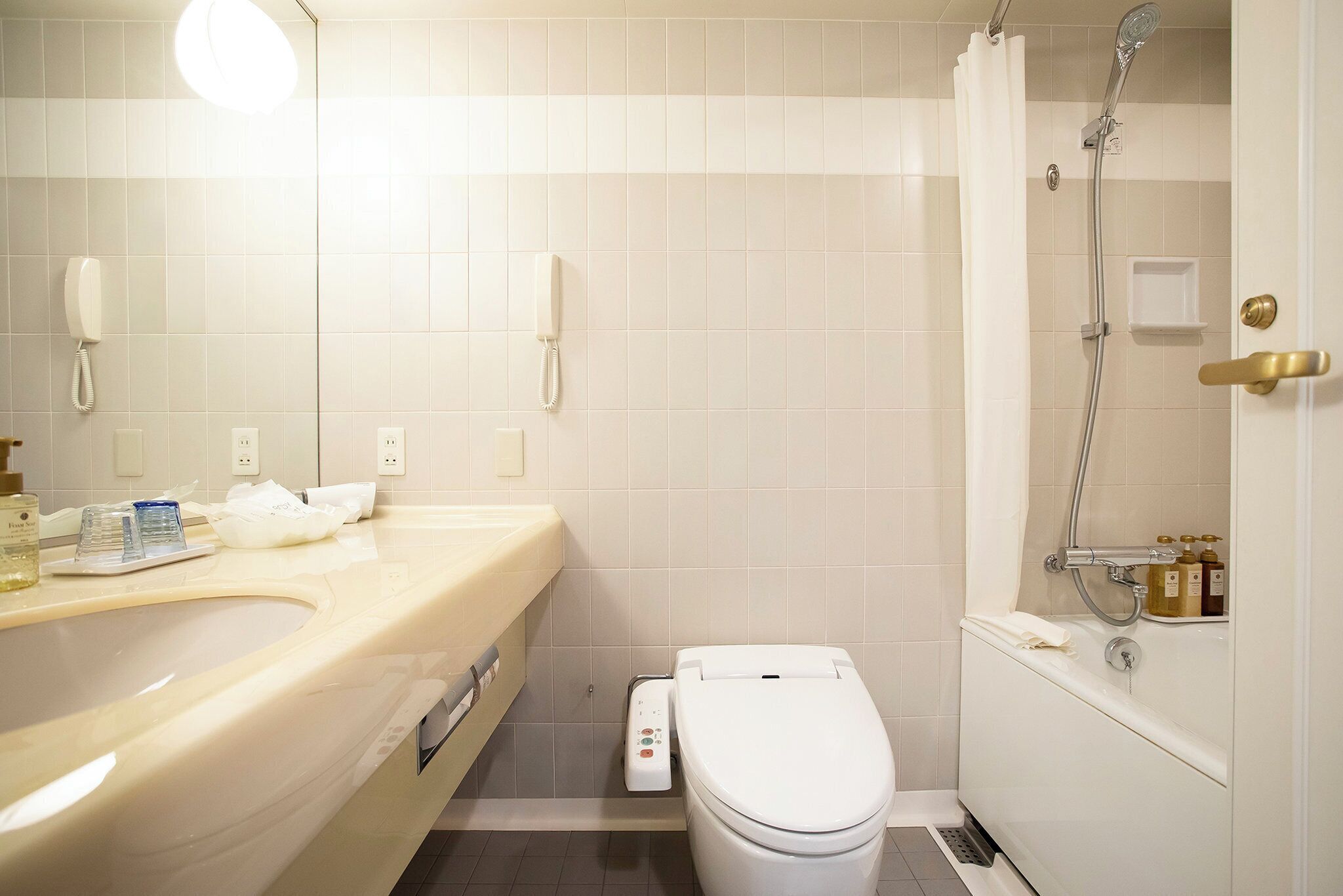 A bathroom with a toilet, sink, and shower.