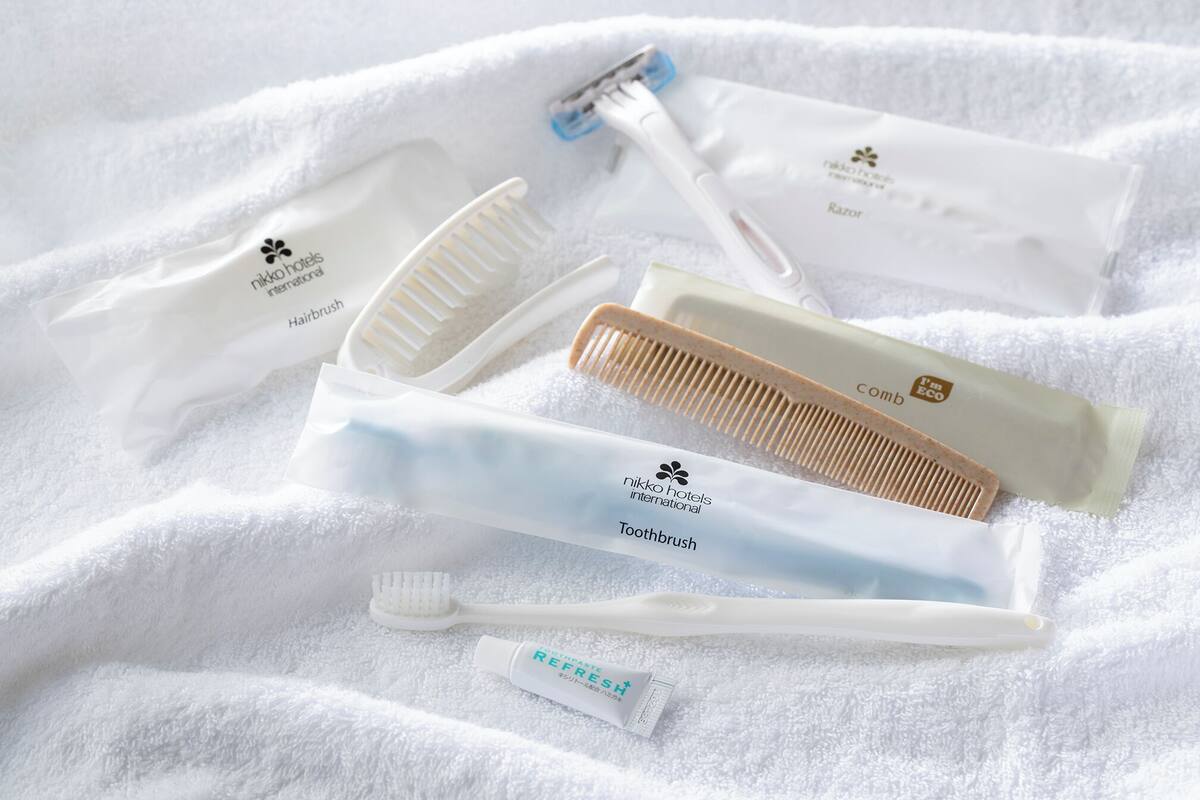 A set of toiletries including a comb, toothbrush, and hairbrush, all labeled with 'nikko hotels international'.