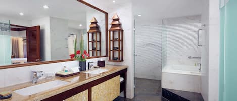 A modern bathroom with a dual sink vanity, a large mirror, and a glass-enclosed shower.