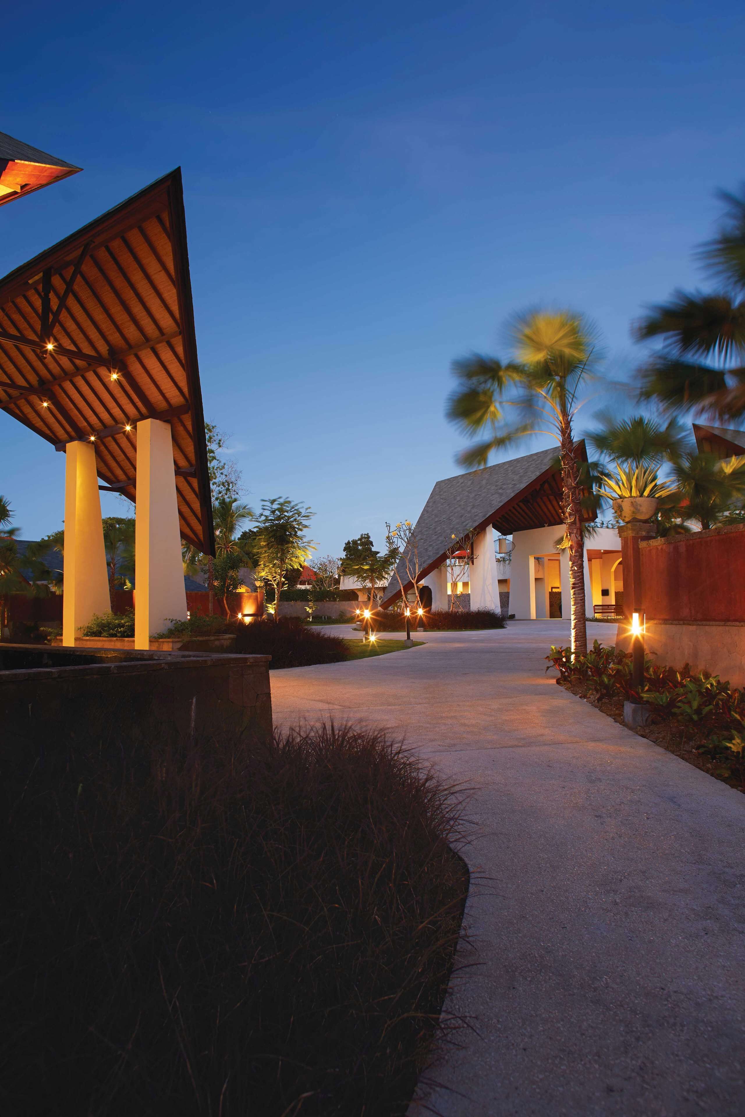 A modern building with a sloped roof and a pathway leading to it.