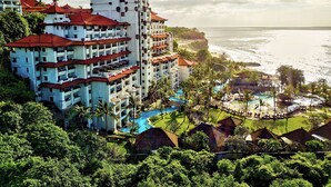 A resort with multiple buildings, a swimming pool, and a beach view. - Hilton Bali Resort (Nusa Dua)