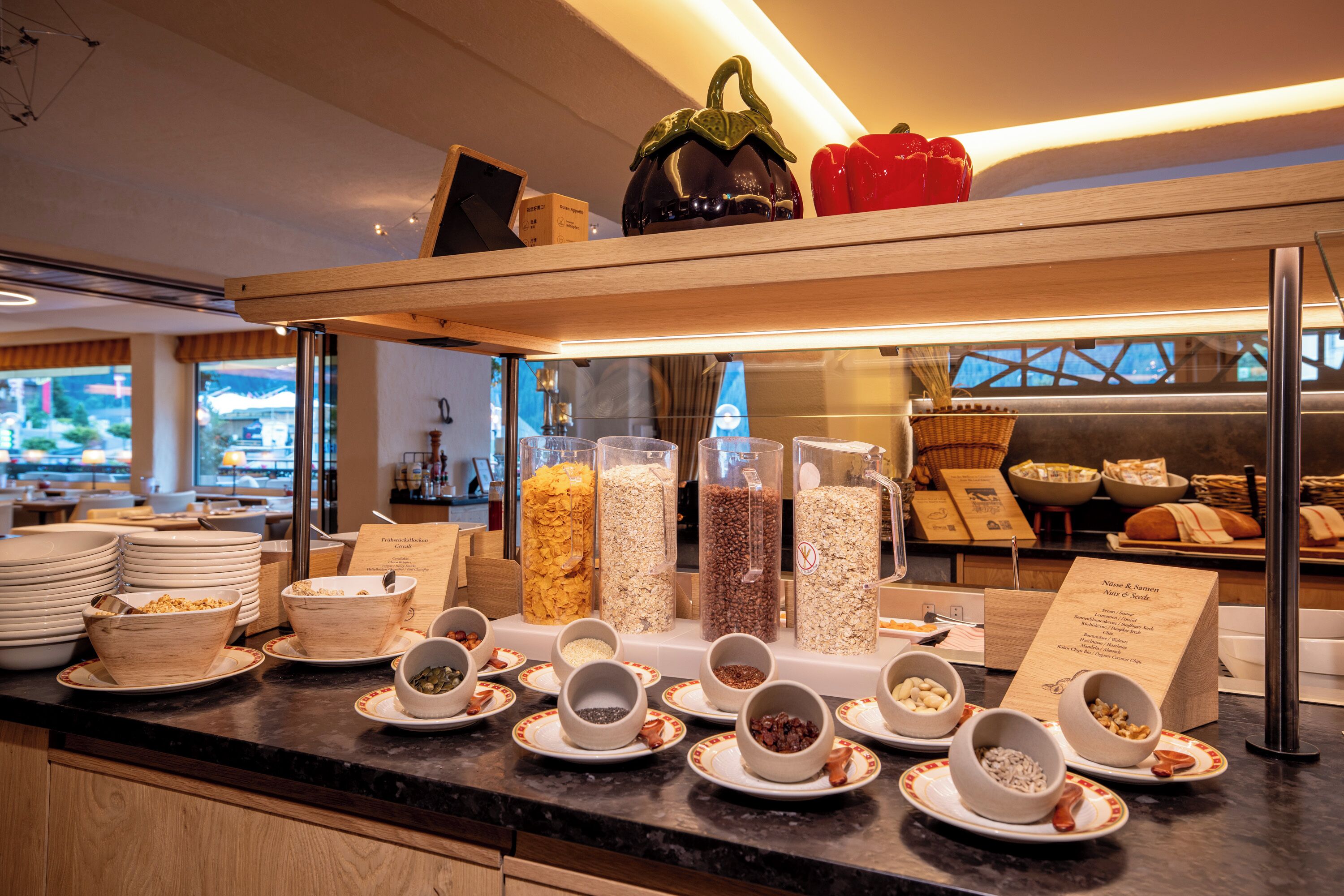 A buffet counter with various food items and containers.