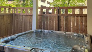 A hot tub with a wooden fence in the background. - Quality Inn & Suites Downtown (Charlottetown)