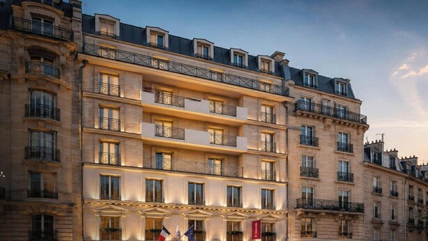 A multi-story hotel with balconies, large windows, and flags. - Clubtrotteur Paris, a Tribute Portfolio Hotel (Paris)