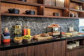 A breakfast buffet with various food items, including fruits, bread, and condiments. - Clubtrotteur Paris, a Tribute Portfolio Hotel (Paris)