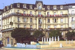 A historic building with a fountain in front, likely a hotel or public building.