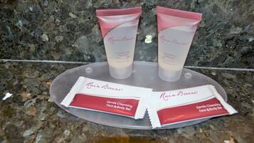 Two tubes of RainBreeze conditioning shampoo and two bars of RainBreeze gentle cleansing face and body bar on a granite countertop.