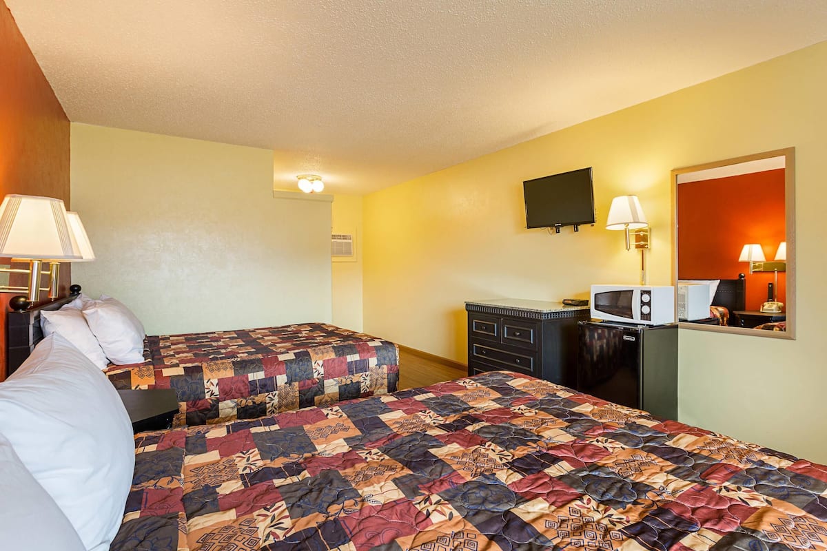 Desk, iron/ironing board, bed sheets
