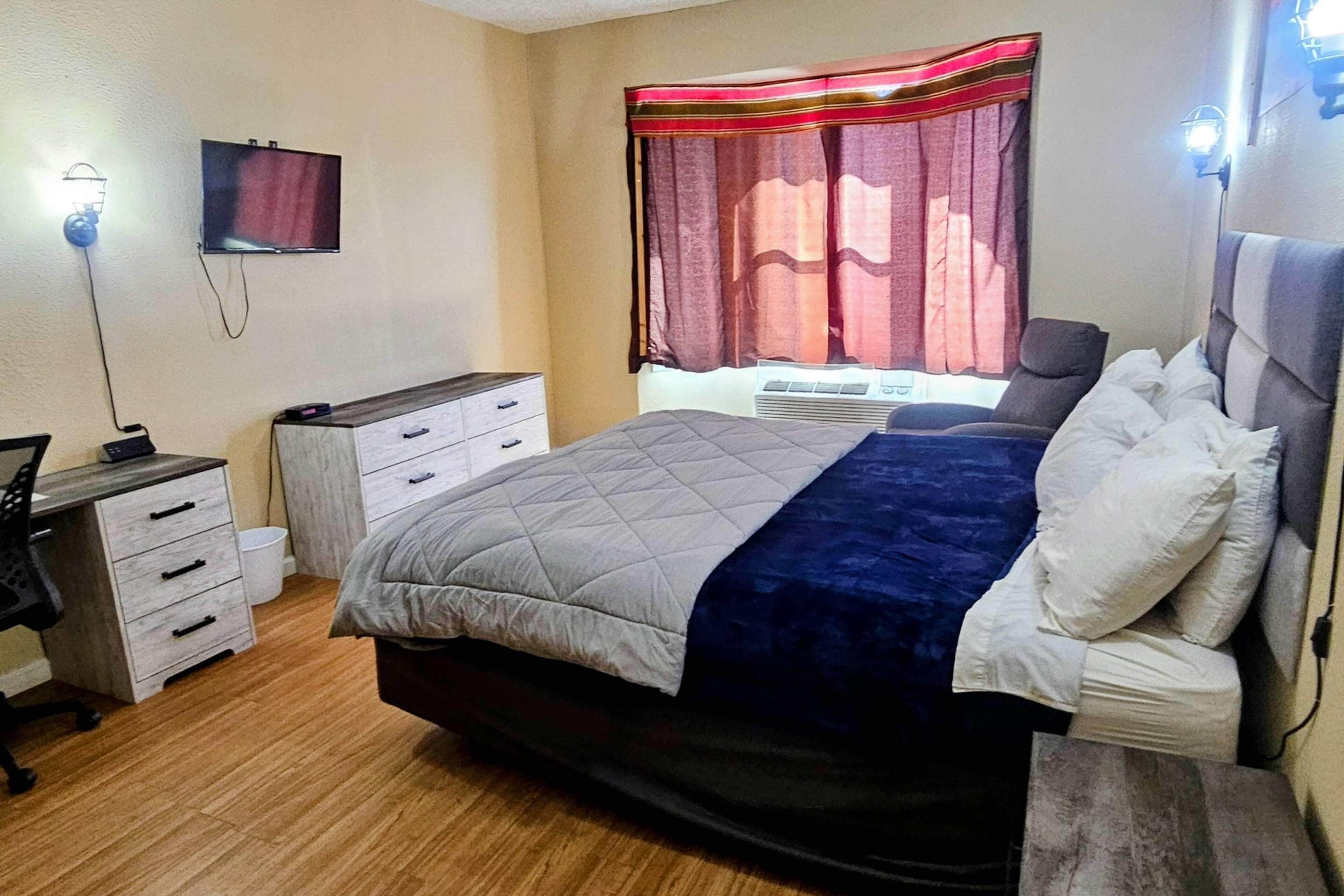 Desk, iron/ironing board, bed sheets