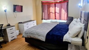 Desk, iron/ironing board, bed sheets