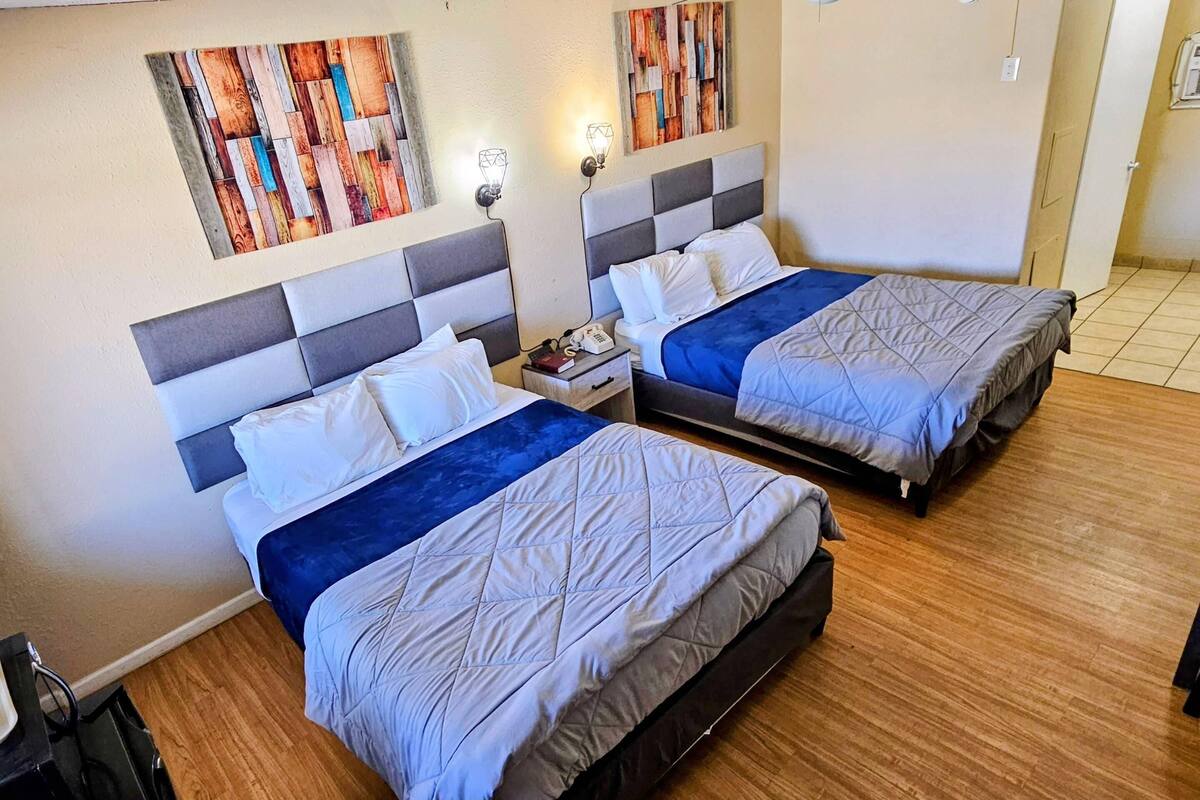 Desk, iron/ironing board, bed sheets