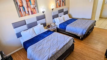 Desk, iron/ironing board, bed sheets