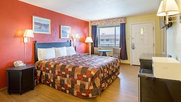 Desk, iron/ironing board, bed sheets