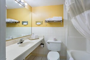 Desk, iron/ironing board, bed sheets
