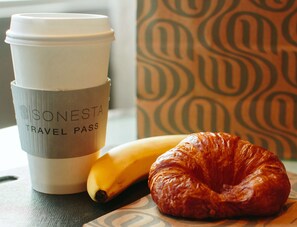 A travel pass, a banana, and a croissant on a table. - Sonesta ES Suites Fresno (Fresno)